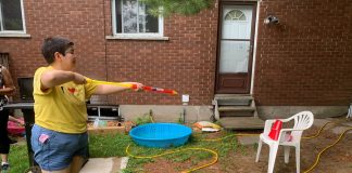 Community Living South Muskoka: Group home resident Vanessa enjoys games in the garden. She loves water activities, especially when they include water guns and the chance to spray people with them. Photo courtesy of CLSM