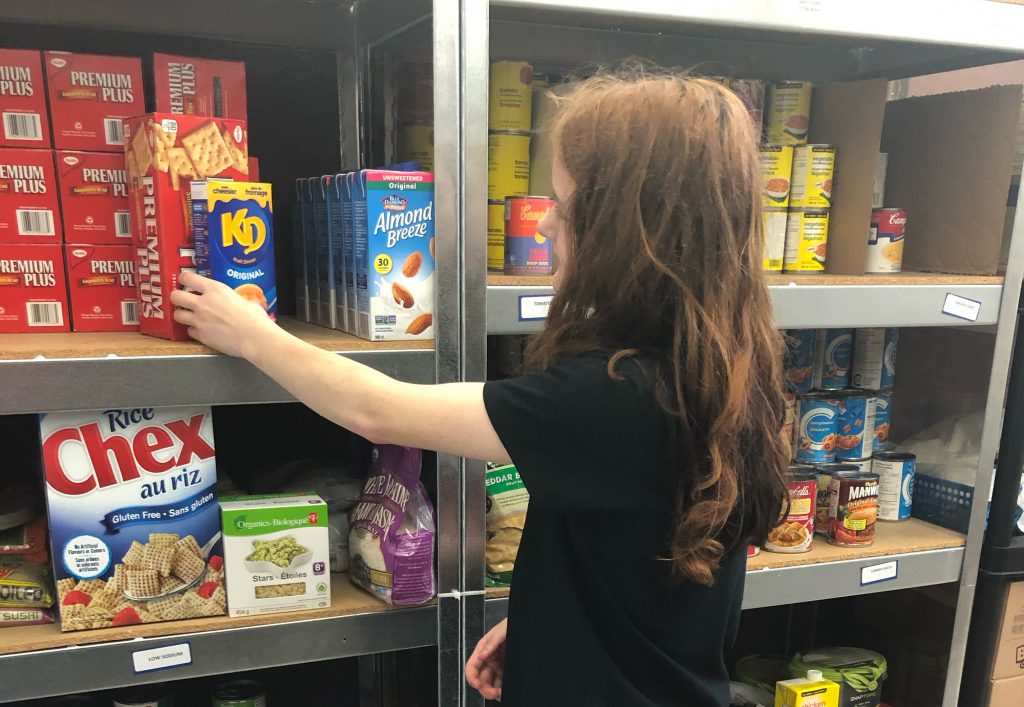 Salvation Army South Muskoka Ministries: The food bank's co-op student Brooke Russell from Gravenhurst High School stocks the shelves. Photo courtesy of Kam Robinson
