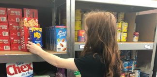 Salvation Army South Muskoka Ministries: The food bank's co-op student Brooke Russell from Gravenhurst High School stocks the shelves. Photo courtesy of Kam Robinson