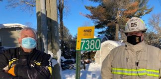 David Snutch and Tony Stong inspect Alternate Power signage for standby generators or solar panels