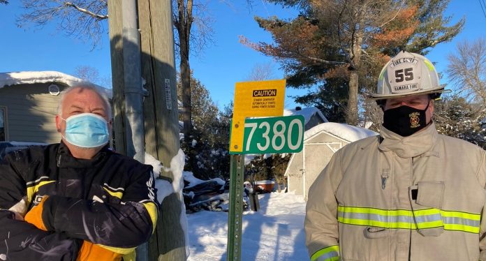 David Snutch and Tony Stong inspect Alternate Power signage for standby generators or solar panels