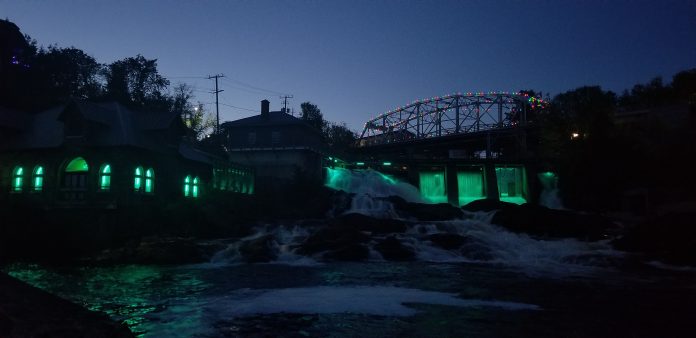 The Bracebridge waterfalls lit up teal for Tourette Syndrome Awareness Month