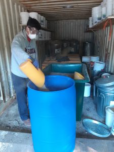 A volunteer fills a barrel with ash in preparation for dispersal. Photo courtesy of Friends of the Muskoka Watershed