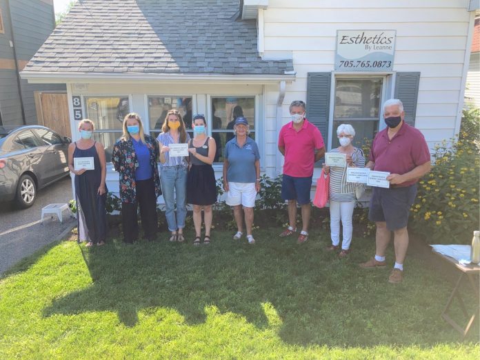 Historic Home Plaque presentation: Susan Daglish of the Muskoka Lakes Museum and Muskoka Lakes Mayor Phil Harding are joined by homeowners involved in the historic plaque program.
