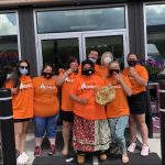 The staff at Wolf Energy Fuels wearing the t-shirts they sold to help raise $50,000 for the Save the Evidence campaign