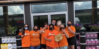 The staff at Wolf Energy Fuels wearing the t-shirts they sold to help raise $50,000 for the Save the Evidence campaign