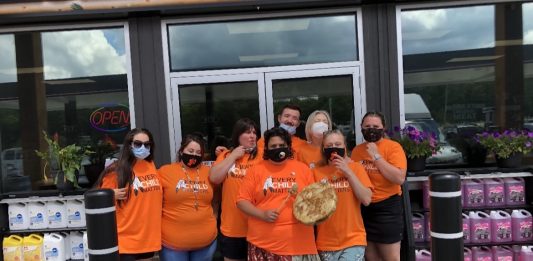 The staff at Wolf Energy Fuels wearing the t-shirts they sold to help raise $50,000 for the Save the Evidence campaign
