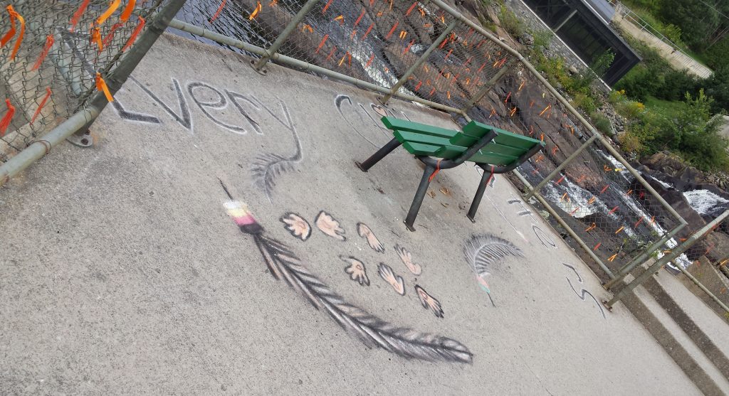 Orange ribbons and chalk art in honour of Indigenous children who died in residential schools