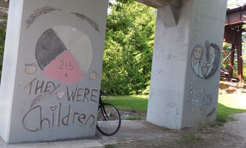 NisoMakwa's chalk art honouring Indigenous children who died in Canada's residential schools. The art says, "They were children" and "Every child matters."
