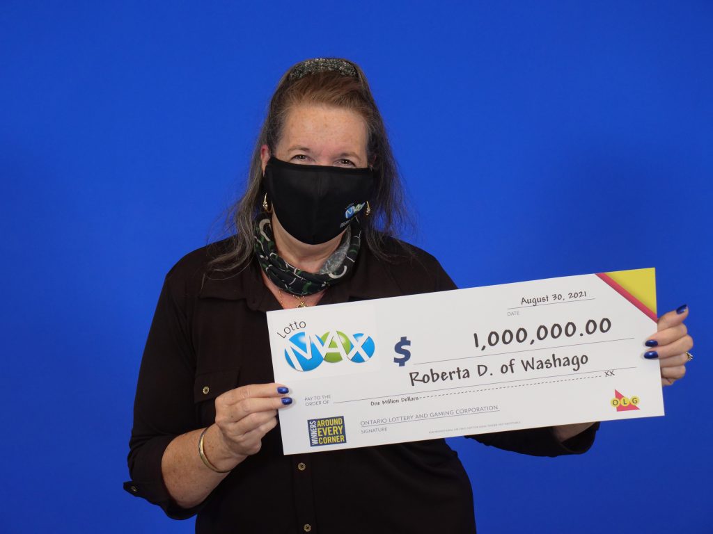 Lotto Max Maxmillions Winner Roberta Davidson of Washago with her $1,000,000,000 cheque.