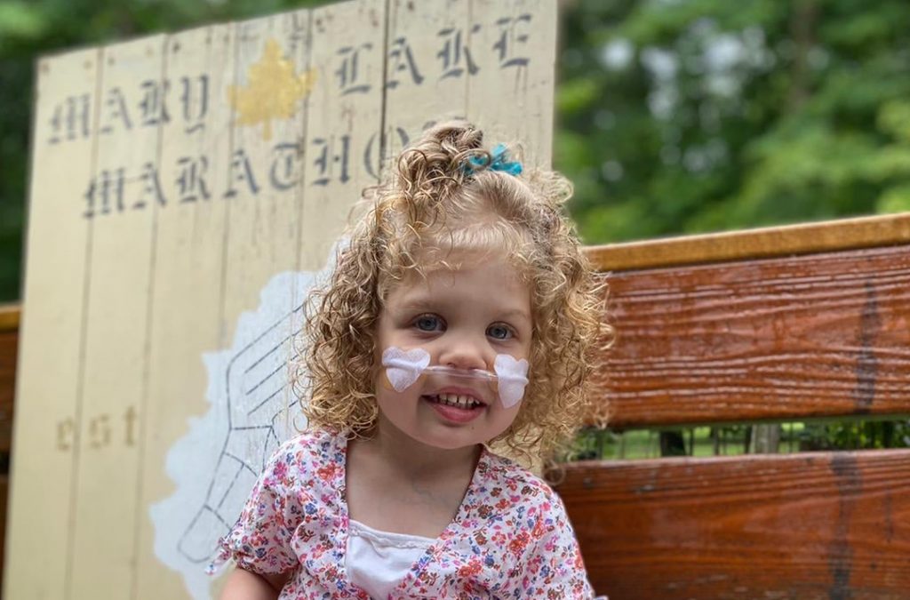 Scarlett Seymour with a sign for the Mary Lake Marathon