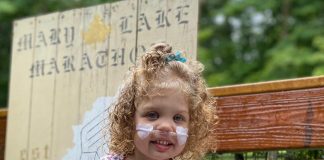 Scarlett Seymour with a sign for the Mary Lake Marathon