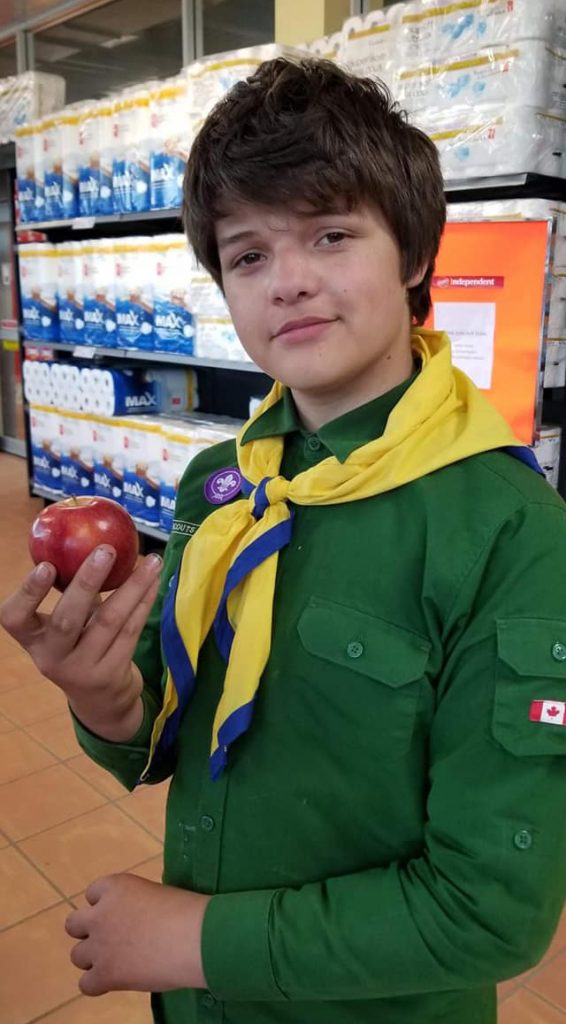 A scout with an apple on Apple Day