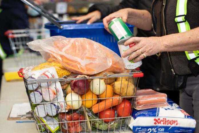 A basket is filled with food items at a Toronto food bank.