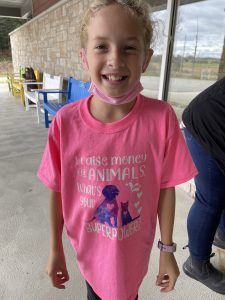 McKenna Phipps wearing a shirt that says, "I raise money for animals. What's your superpower?"