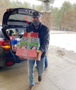 A volunteer distributes shoeboxes for the seventh annual Muskoka Shoebox Project