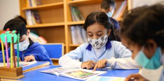 Children wear masks during a return to in-person learning at schools.