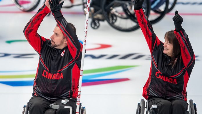 Jon Thurston and Ina Forrest celebrate after Canada advances to the semifinals in wheelchair curling. Photo courtesy of the Canadian Paralympic Committee