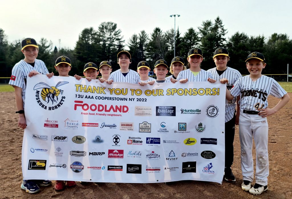 Muskoka Hornets U12 AAA Baseball Team with sponsor banner