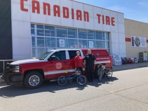 The Muskoka Lakes Fire Department picks up their door prize of two bicycles and helmets for family safety night on April 28. Photo courtesy of the Muskoka Lakes Fire Department via Facebook