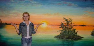 Bracebridge mural artist Kimberly Rideout with her latest mural at the Pines Long-Term Care Home