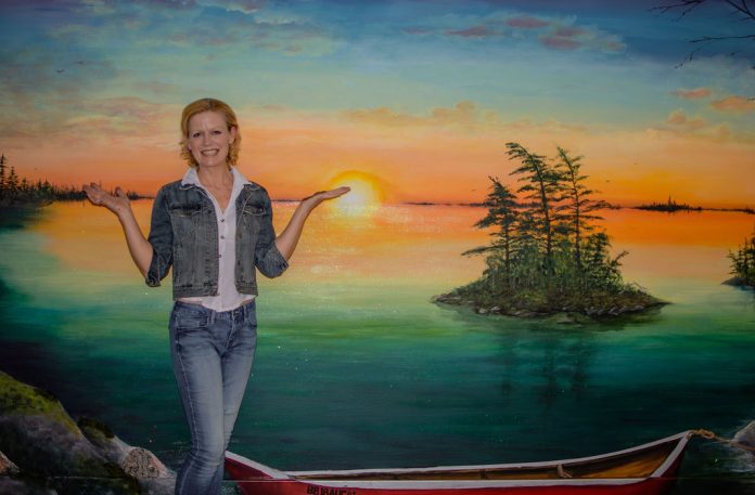 Bracebridge mural artist Kimberly Rideout with her latest mural at the Pines Long-Term Care Home