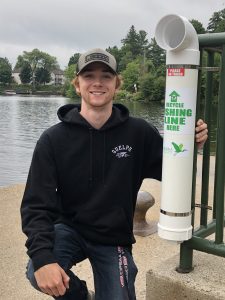Program Coordinator Ayden Veitch with a recycling tube at Bracebridge Bay Park