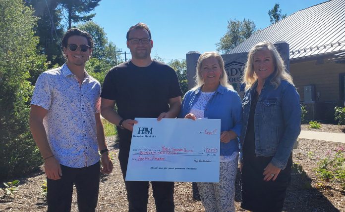 Butterfly-Lake-Resort-Donation Joey Braden, Hospice Muskoka Public Relations and Fundraising Specialist Matt Steer, Butterfly Lake Resort owner Lynn Braden and resort resident Heather Neuman