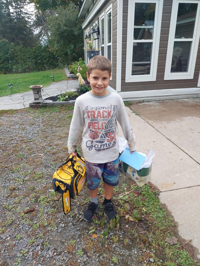 Khai Tonello with his tackle box and fishing equipment