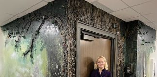 Artist Kimberly Rideout with her second mural at Andy's House