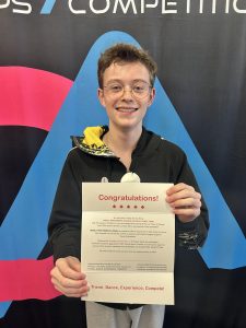 Ollie MacDonald with their letter inviting them to the World Performers Canada National Dance Team