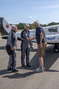 Muskoka cottager Bruce Hodge greets pilots Bob Bates and Barry “Baz” Payne