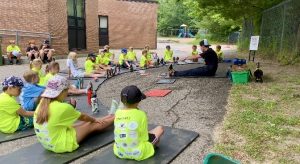 Kids Run Club leader and teacher Robin Mounsteven leads stretches at run club