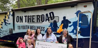 Muskoka 100 People Who Care organizers present a cheque to MiND-AID program manager and navigator Mariko Fletcher