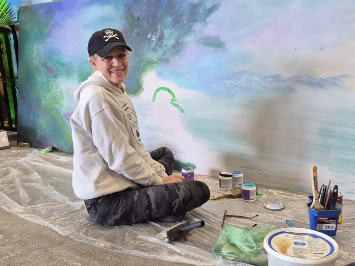 Kimberly Rideout painting a submission mural at Home Depot Bracebridge. Photo by Pamela Ewert.