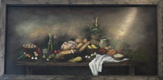 Kimberly Rideout, under her donated mural to the Manna Food Bank, Bracebridge, Ont.